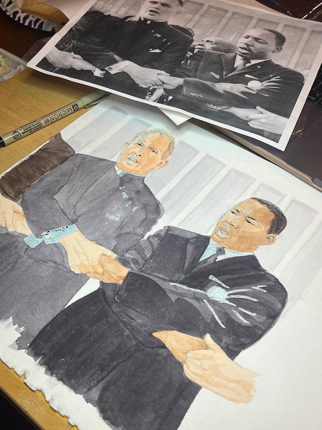 The cover watercolor in progress beside the archival reference photograph